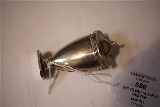 A George III silver vase shaped nutmeg grater, with hinged lid and base, 67mm.